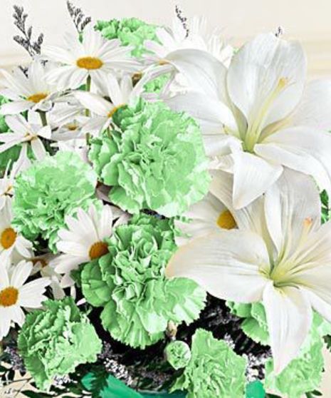 Closeup of green carnations and white lilies and daisies.